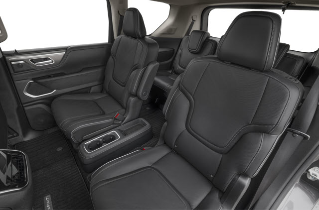 Interior of a spacious 2026 INFINITI QX80 SUV with black leather seats and ample legroom.